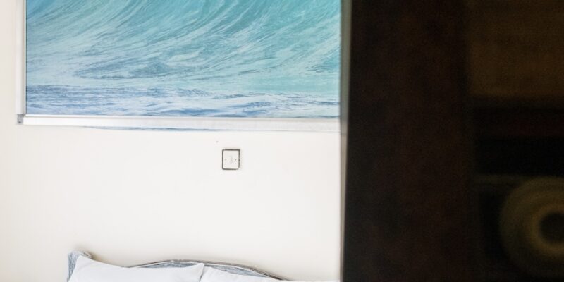 Salty Loving Surf Essaouira Surf & Kite Packages with accommodations - Comfy bed with Wave artwork