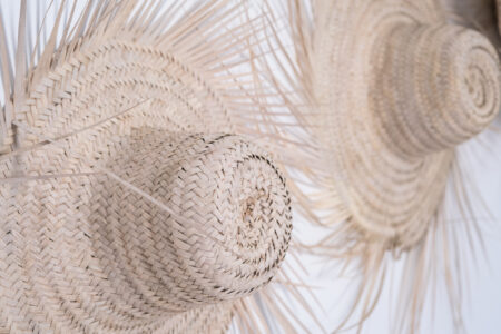 LOVING SURF SALTY BOUTIQUE HOTEL ESSAOUIRA MOROCCO-5372 Decor straw hats on wall in Bright and sunny Triple private room in Salty hotel beside the beach in Essaouira