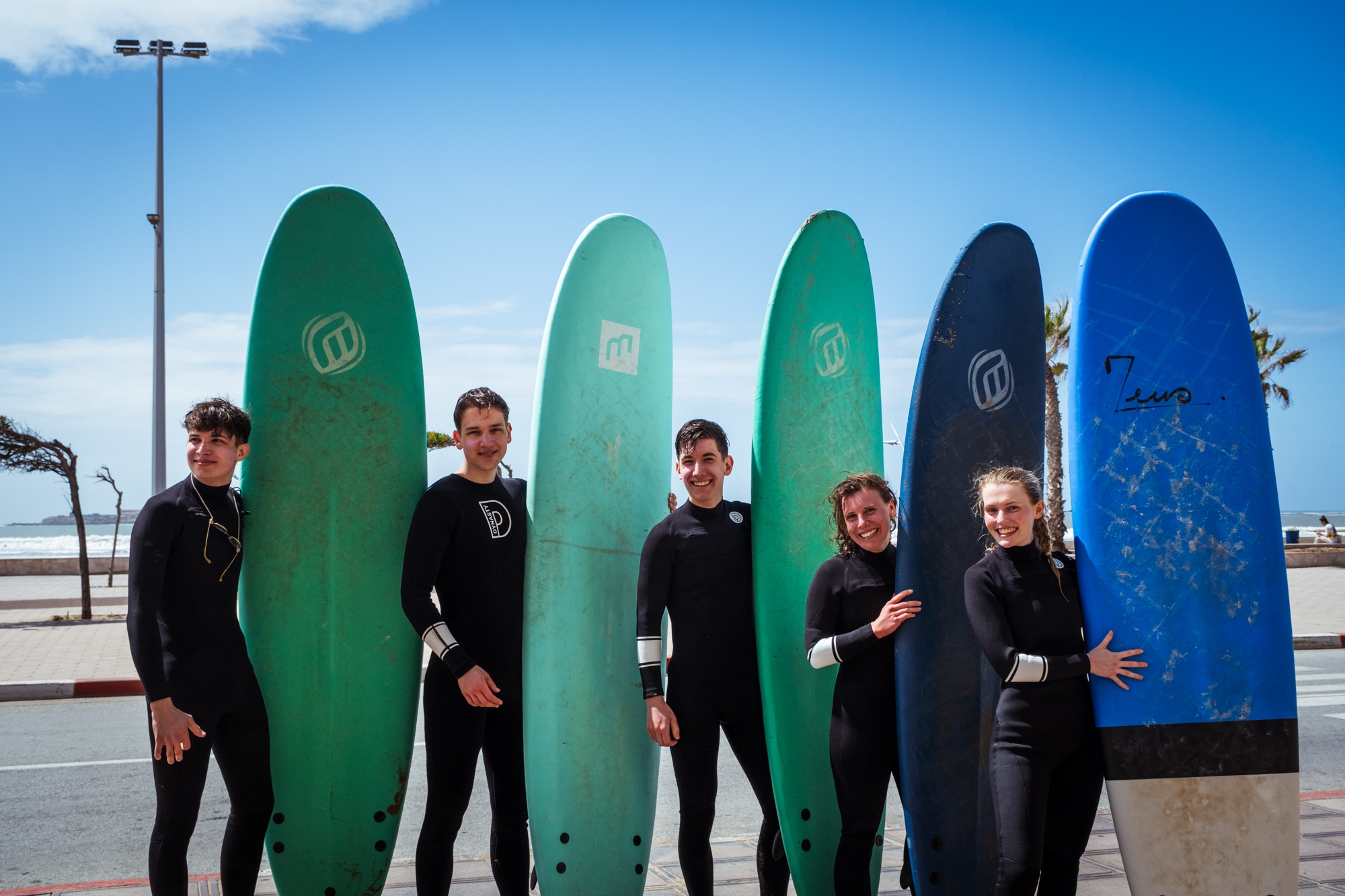 Loving surf Surf shop in Essaouira Morocco with sign and surfboards and students before their surf lesson