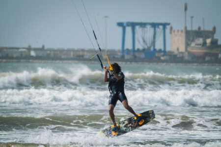 Loving Surf Kite instructor surfing the waves in front of the Essaouira Port