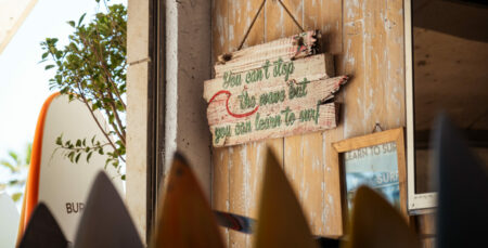 can't stop the wave but you can learn to surf artwork in loving surf shop in essaouira