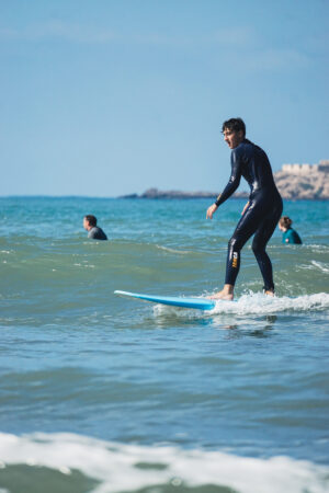 Surfer riding wave in Essaouira Morocco with Loving Surf