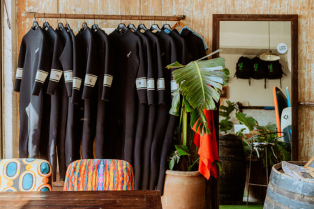 wetsuits hanging in surf shop & surf, wing and kite school in essaouira Morocco Loving Surf