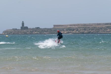 Kitesurfer jumping in Essaouira Bay in front of Mogador Island in Essaouira Morocco with Loving Surf